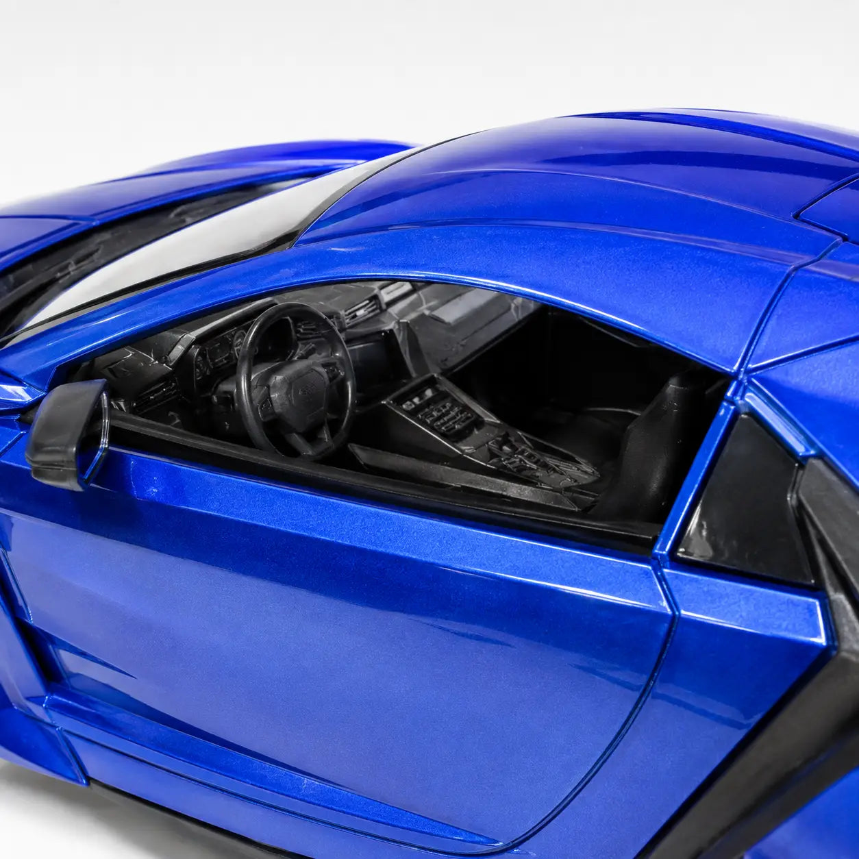 Close-up view of the detailed black interior and dashboard inside the blue Bonzer RC car