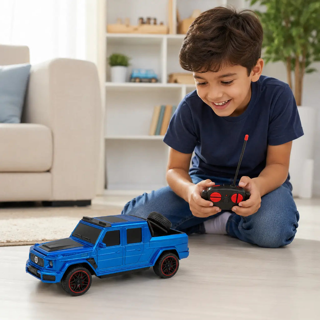 Child playing with blue 1:14 scale RC pickup truck using wireless remote control