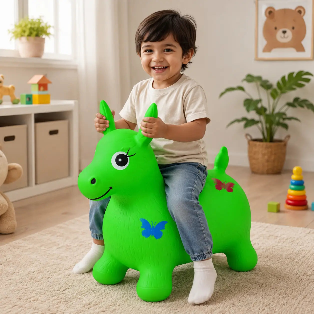 Child playing on green inflatable animal hopper ride-on bouncing toy