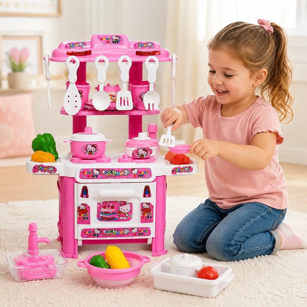 Girl playing with pink Hello Kitty kids kitchen play set with cooking utensils, pots and pretend vegetables