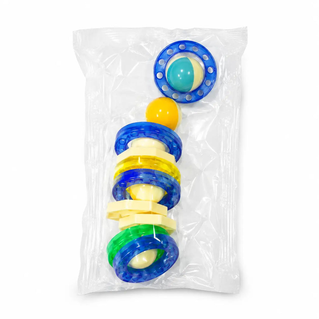 Close-up of colorful rings, connectors and rolling ball accessories included with magnetic pipeline building blocks.