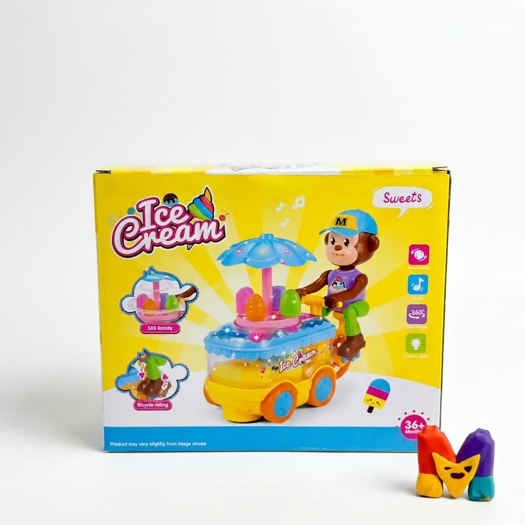 A children's toy ice cream cart set shown with its retail box on a light gray studio background. The box is bright yellow with colorful graphics of an ice cream cart, a monkey character, and icons indicating features like music, lights, and 360-degree rotation.