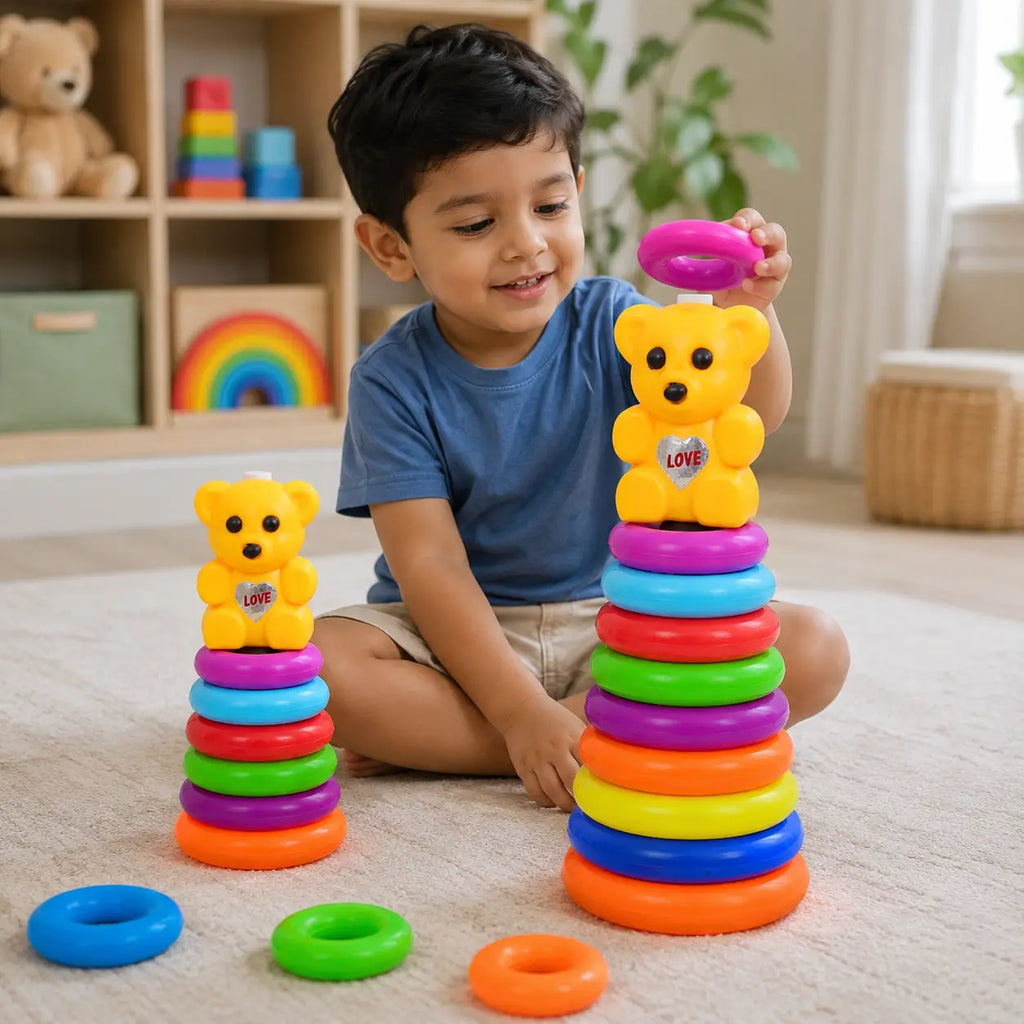 Young child playing with colorful teddy bear stacking rings toy in big and small sizes during indoor playtime